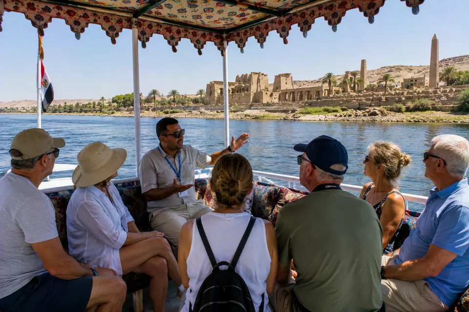 Guide and tourists on a boat to Philae Temple, Aswan