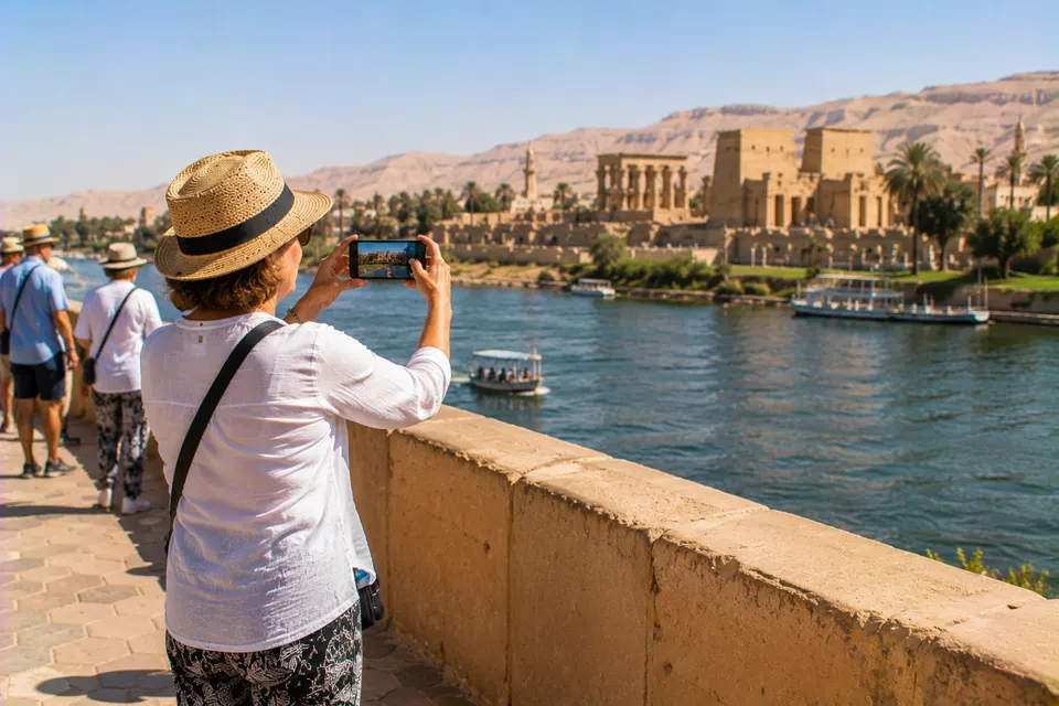 Tourist photographing Philae Temple in Aswan