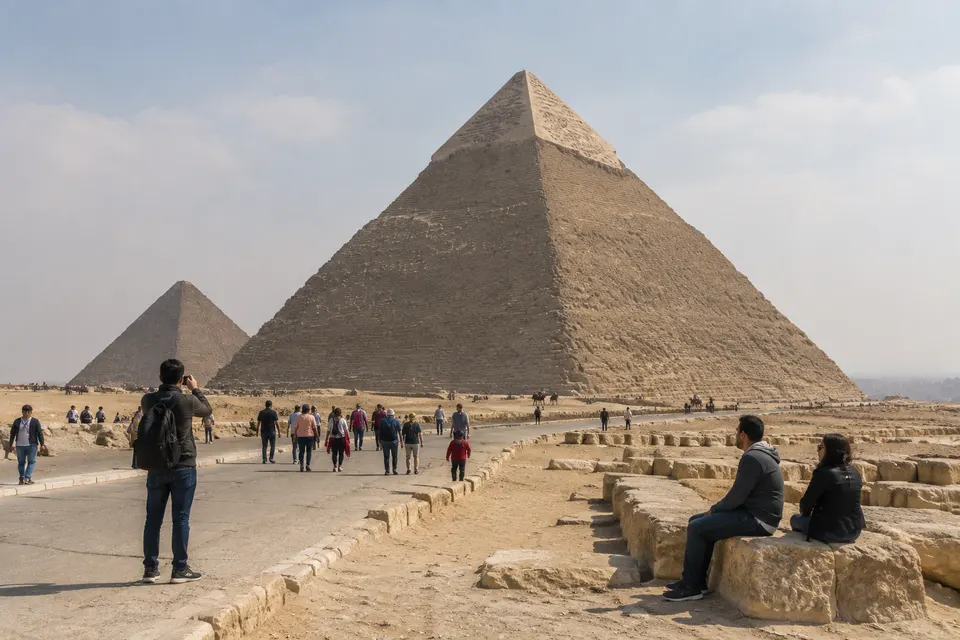 Tourists at the Giza pyramids on a hazy afternoon