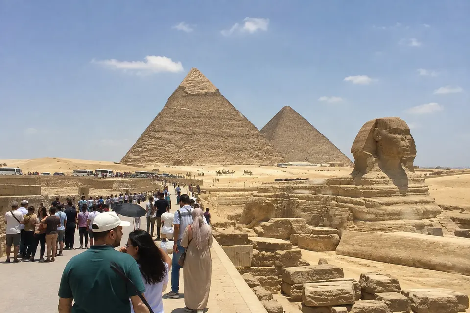 Visitors in front of the Sphinx and the pyramids