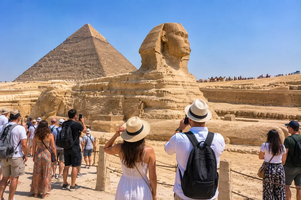 Tourists photographing the Sphinx with the Khafre pyramid behind