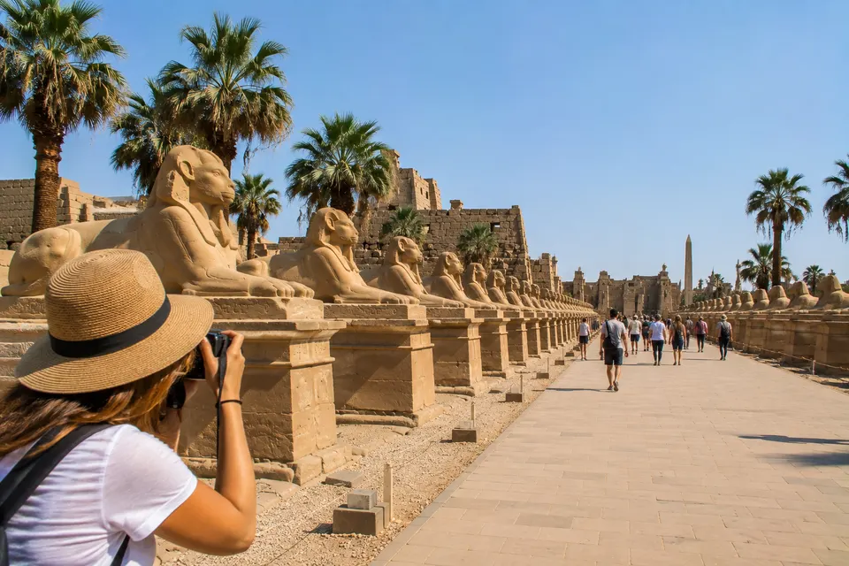 Tourist photographing the Avenue of Sphinxes
