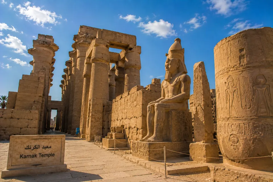 Seated colossus and carved columns at Karnak