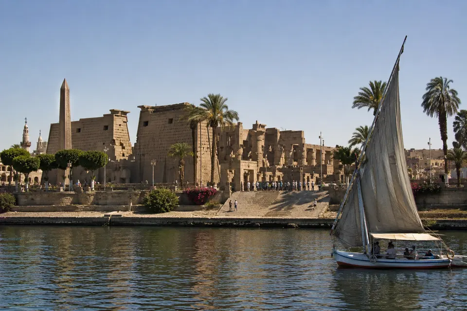 View of Luxor Temple from the Nile with a felucca