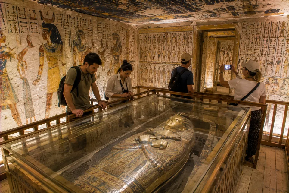 Visitors beside a sarcophagus under a starry tomb ceiling